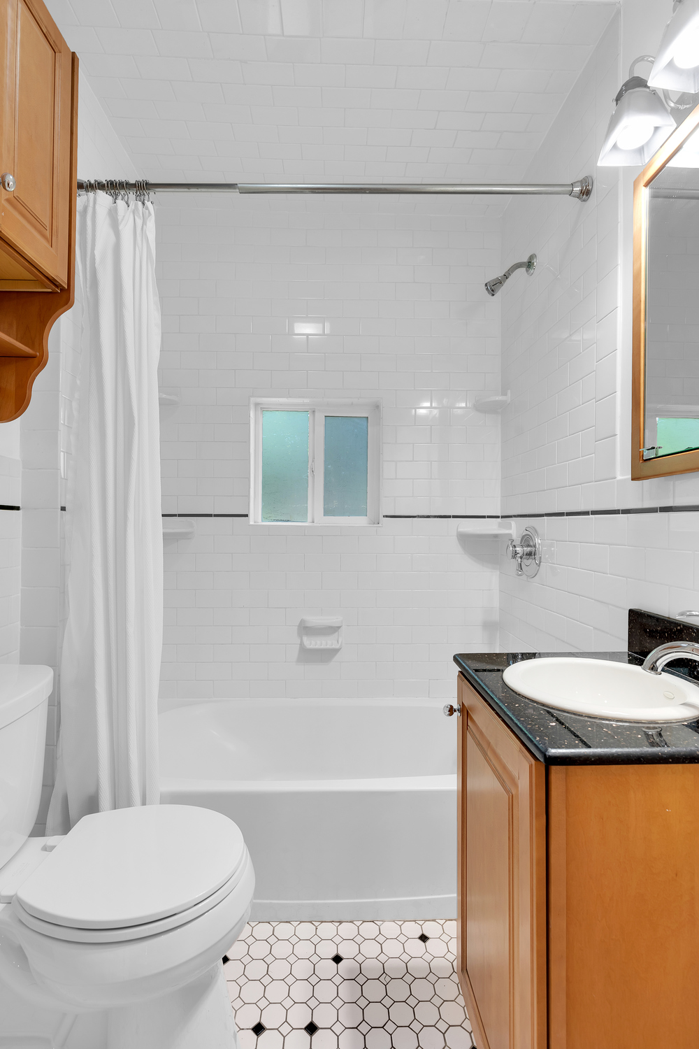 242-09 Pine Street Queens, NY 11363 - Photo 11 of 21 a bathroom with a sink a toilet and shower