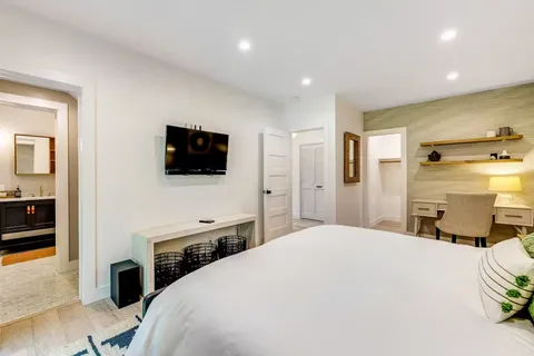 a bedroom with a bed and a flat screen tv
