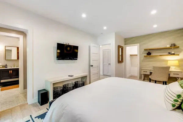 a bedroom with a bed and a flat screen tv