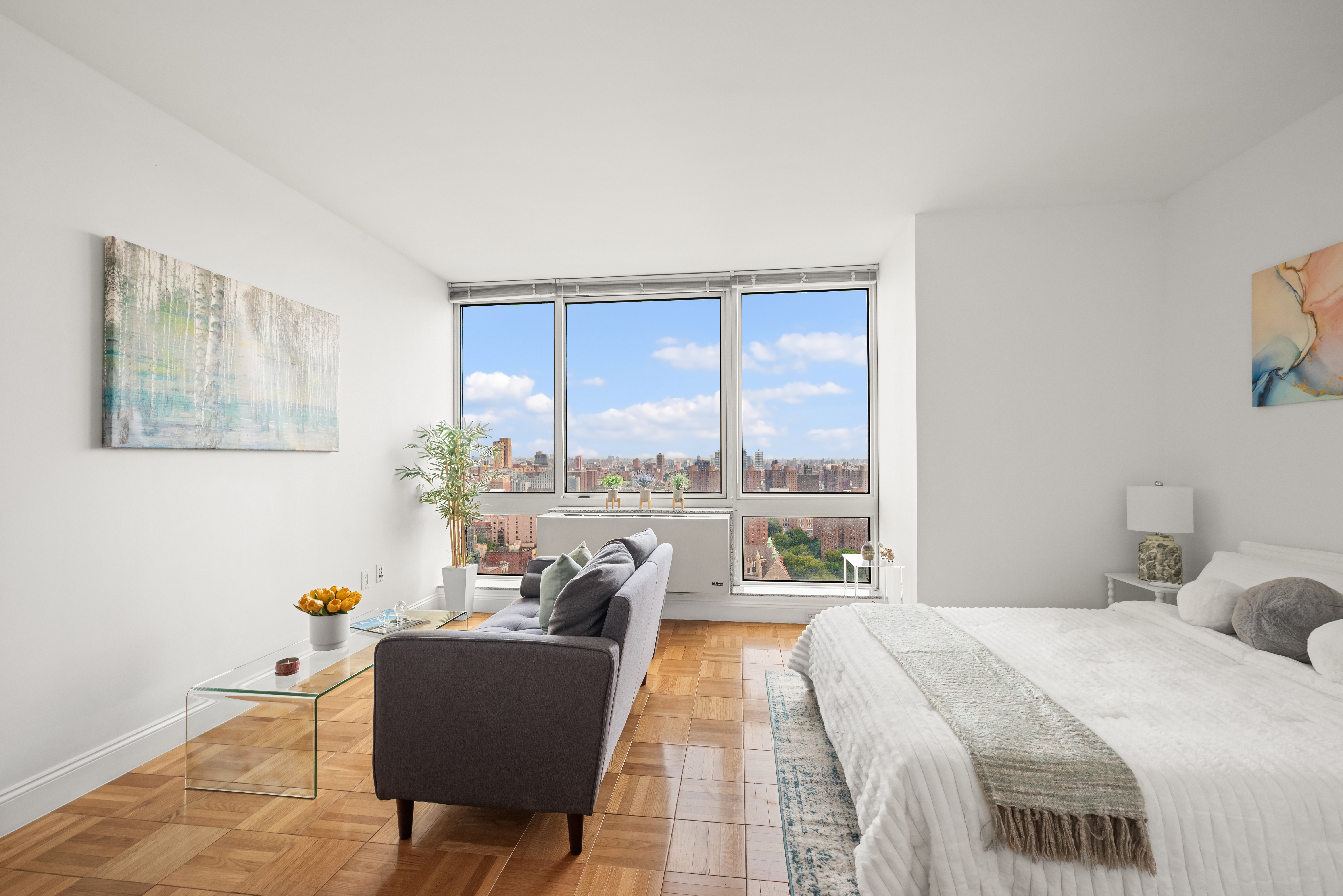 a bedroom with a bed and a couch next to a window
