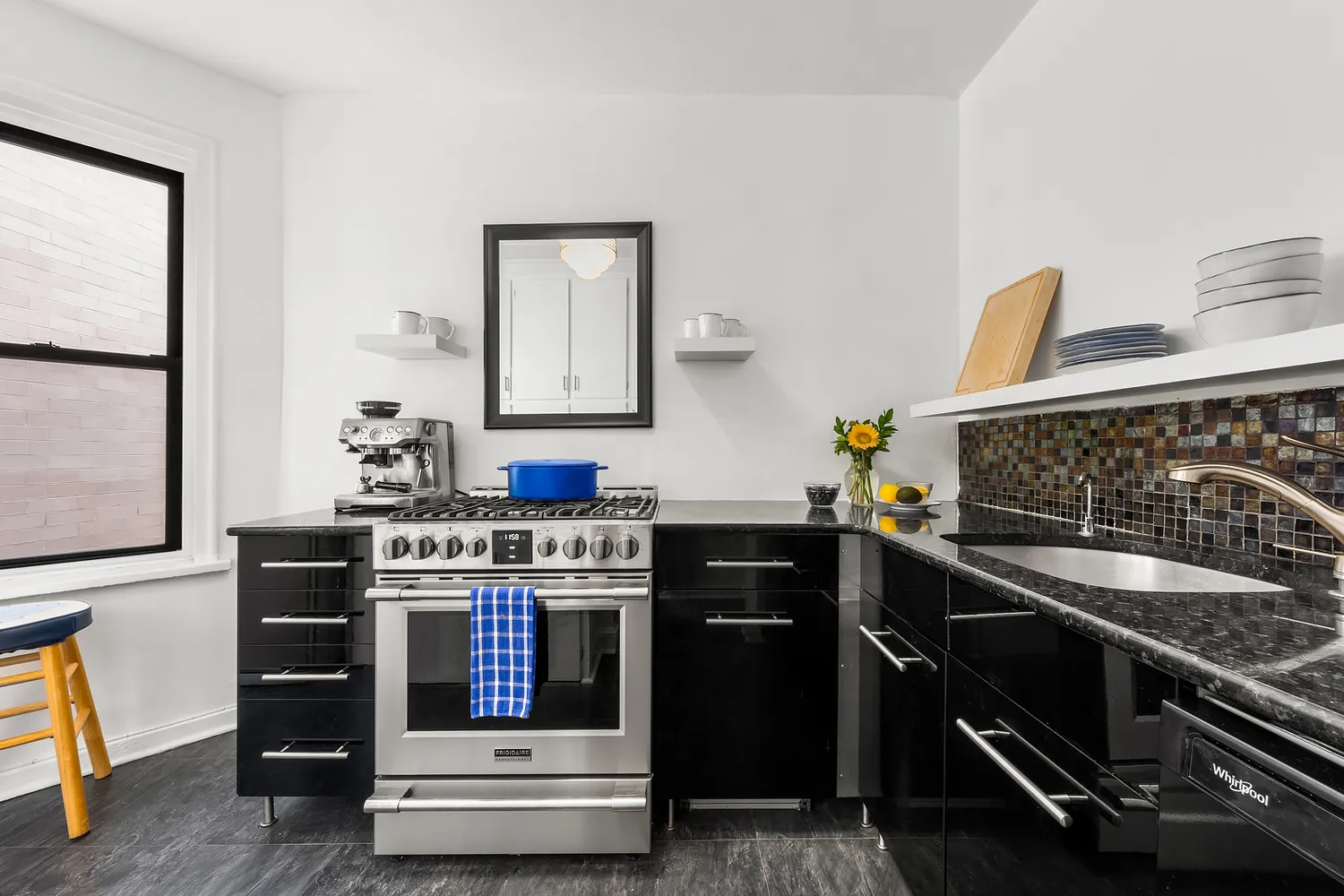 a kitchen with stainless steel appliances granite countertop a stove and a sink