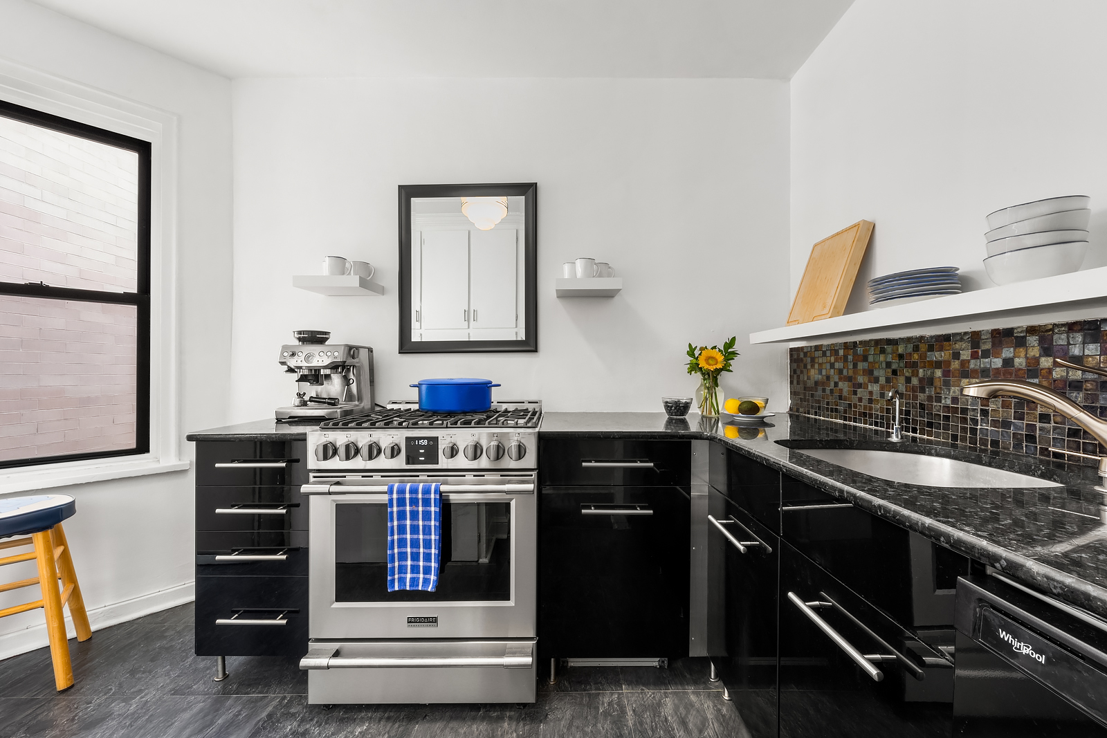 166 West 22nd Street, Unit 6C Manhattan, NY 10011 - Photo 7 of 11 a kitchen with stainless steel appliances granite countertop a stove and a sink