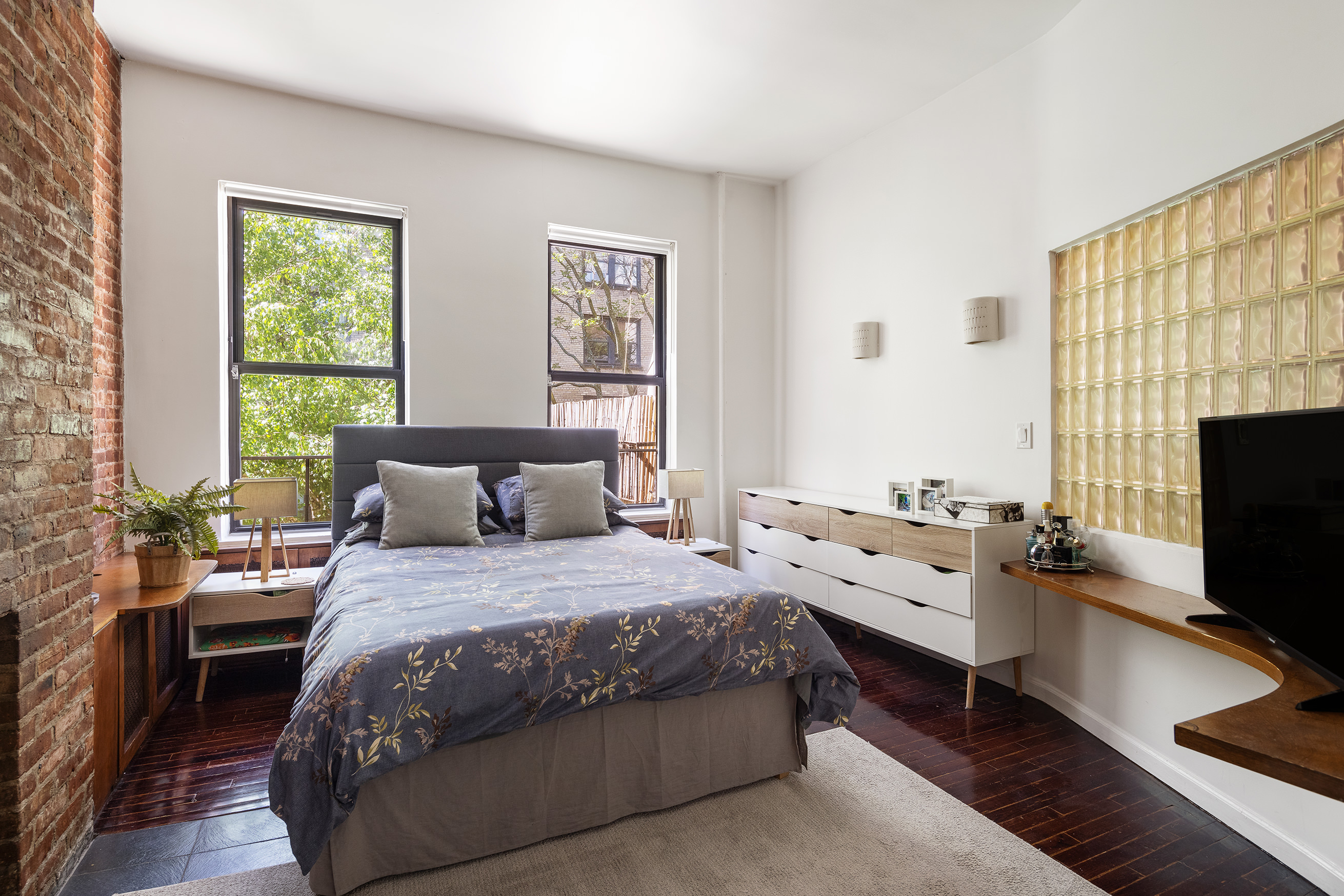 144 West 80th Street Manhattan, NY 10024 - Photo 15 of 22 a bedroom with a bed and a flat screen tv