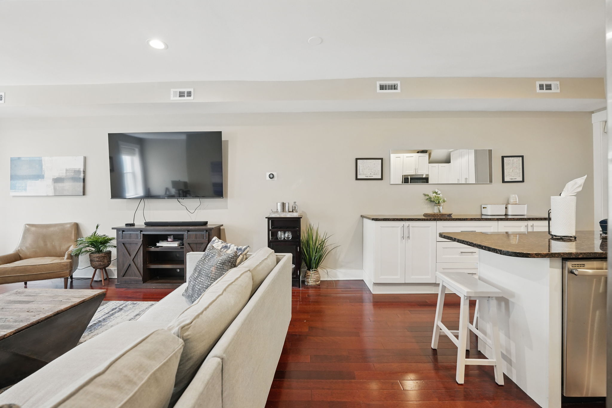 28 Q Street Northeast, Unit 2 Washington, DC 20002 - Photo 6 of 41 a living room with stainless steel appliances granite countertop wooden floor a fireplace a flat screen tv and a sink