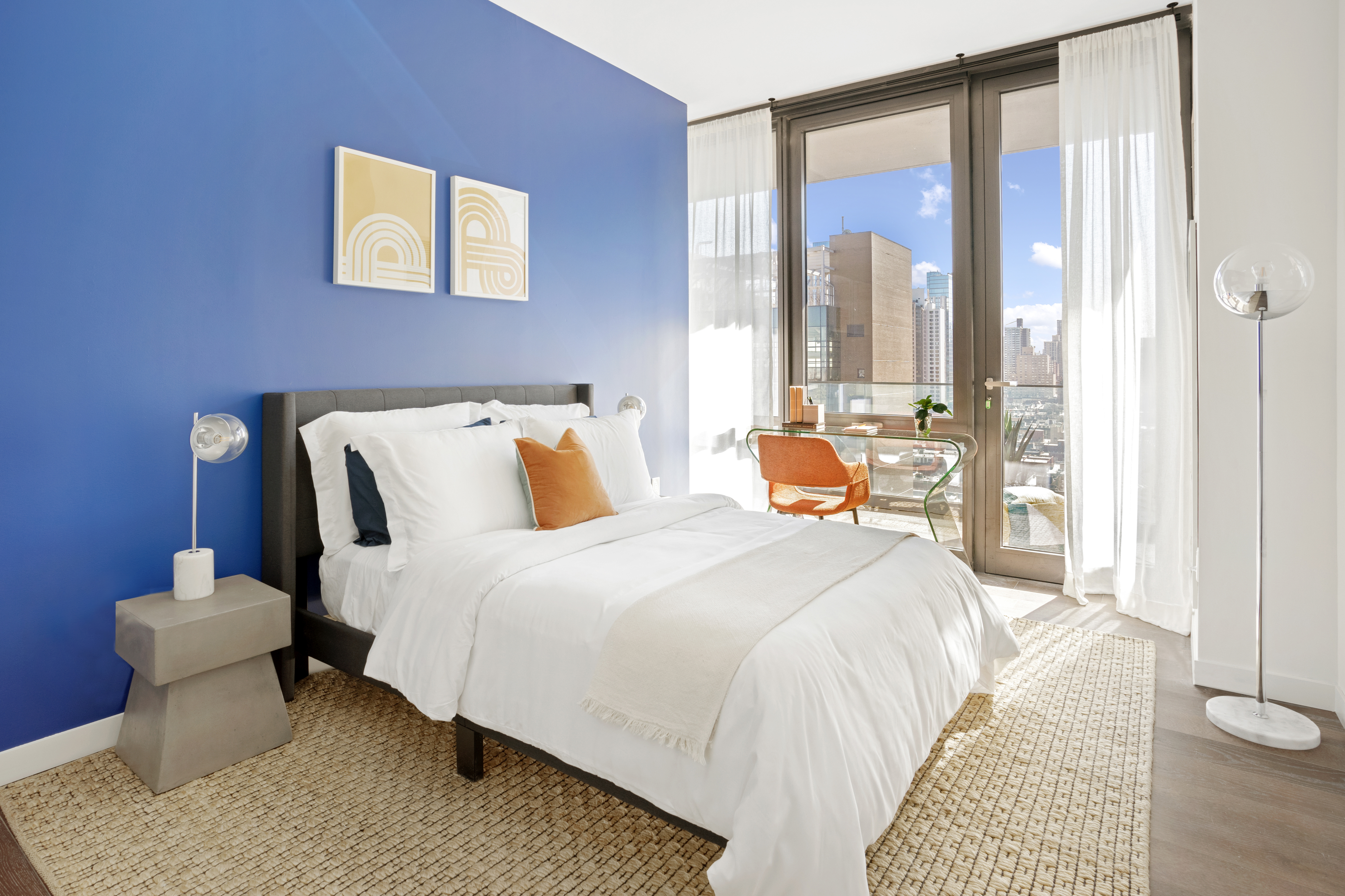 302 East 96th Street, Unit PH6 Manhattan, NY 10128 - Photo 8 of 13 a bedroom with a bed and a large window