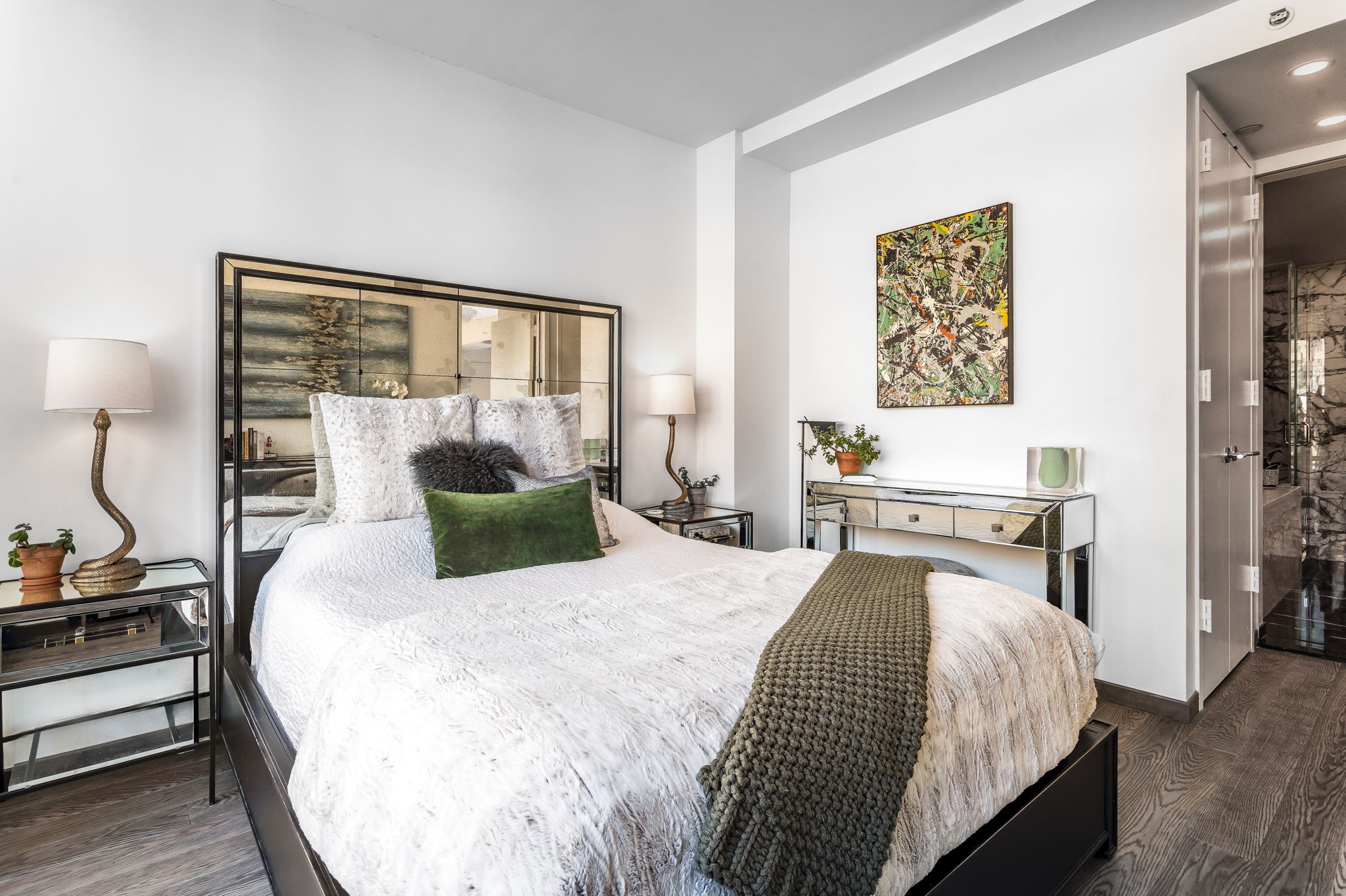 350 West 53rd Street, Unit PHB Manhattan, NY 10019 - Photo 16 of 34 a bedroom with a bed and wooden floor