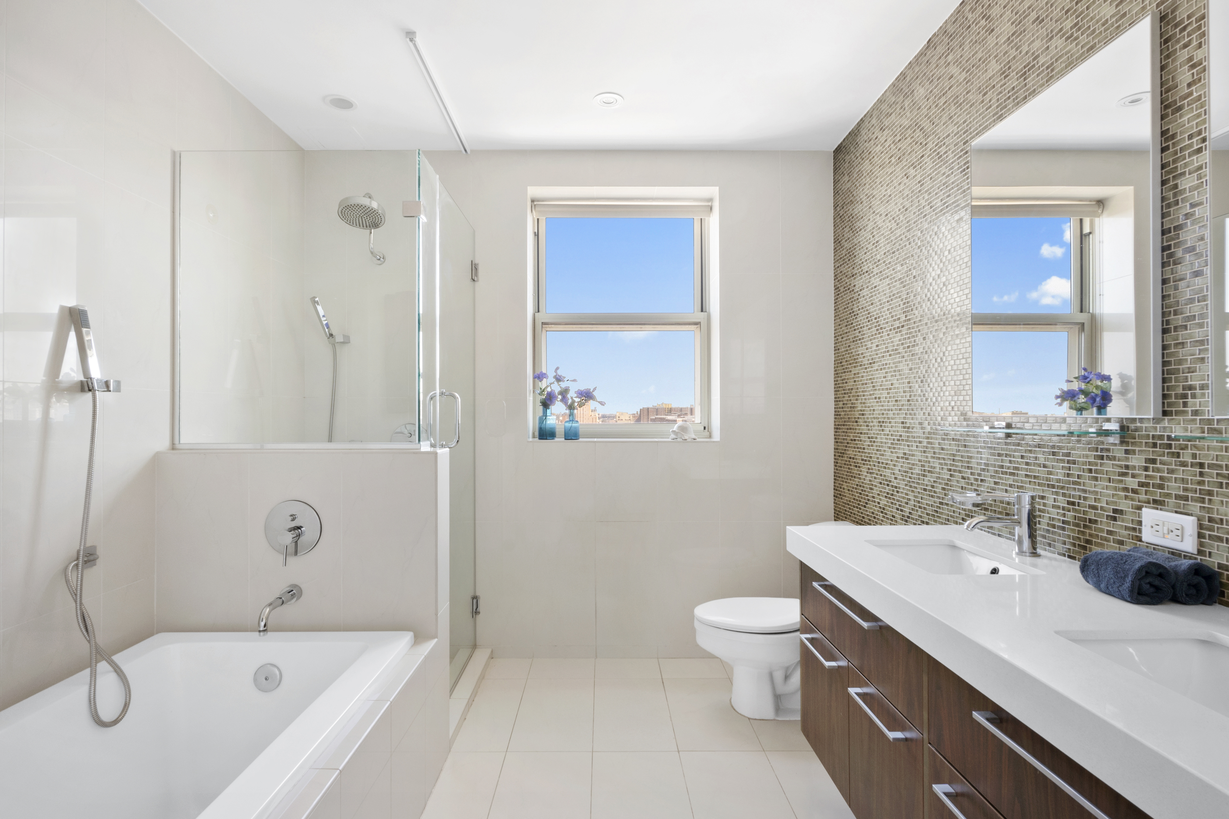301 West 115th Street, Unit PH4C Manhattan, NY 10026 - Photo 5 of 15 a bathroom with a tub sink toilet and mirror