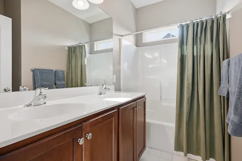 a view of a house with a big yard and large trees