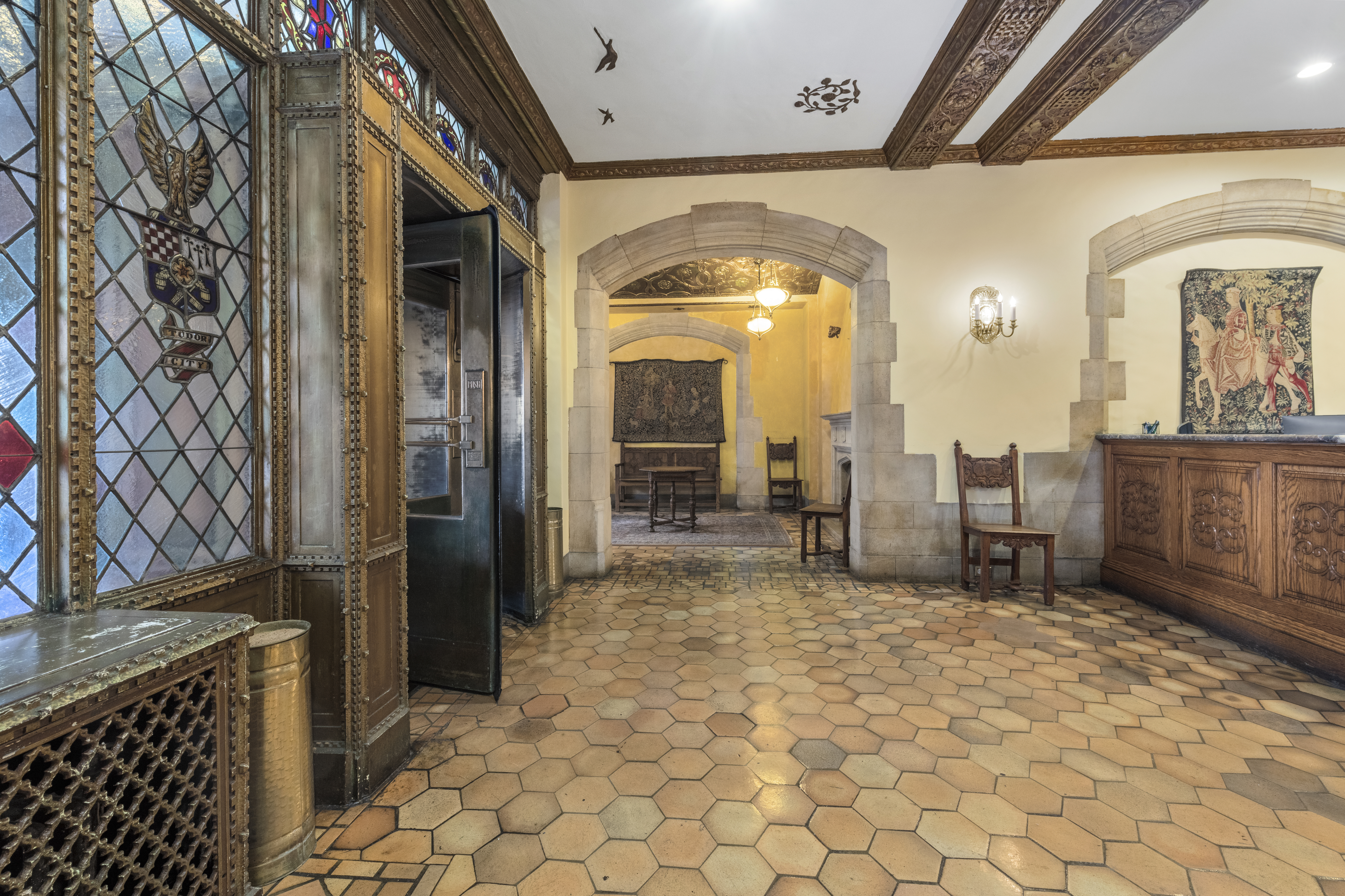 25 Tudor City Place, Unit 1419 Manhattan, NY 10017 - Photo 9 of 14 a view of a hallway with a chair and dining table view
