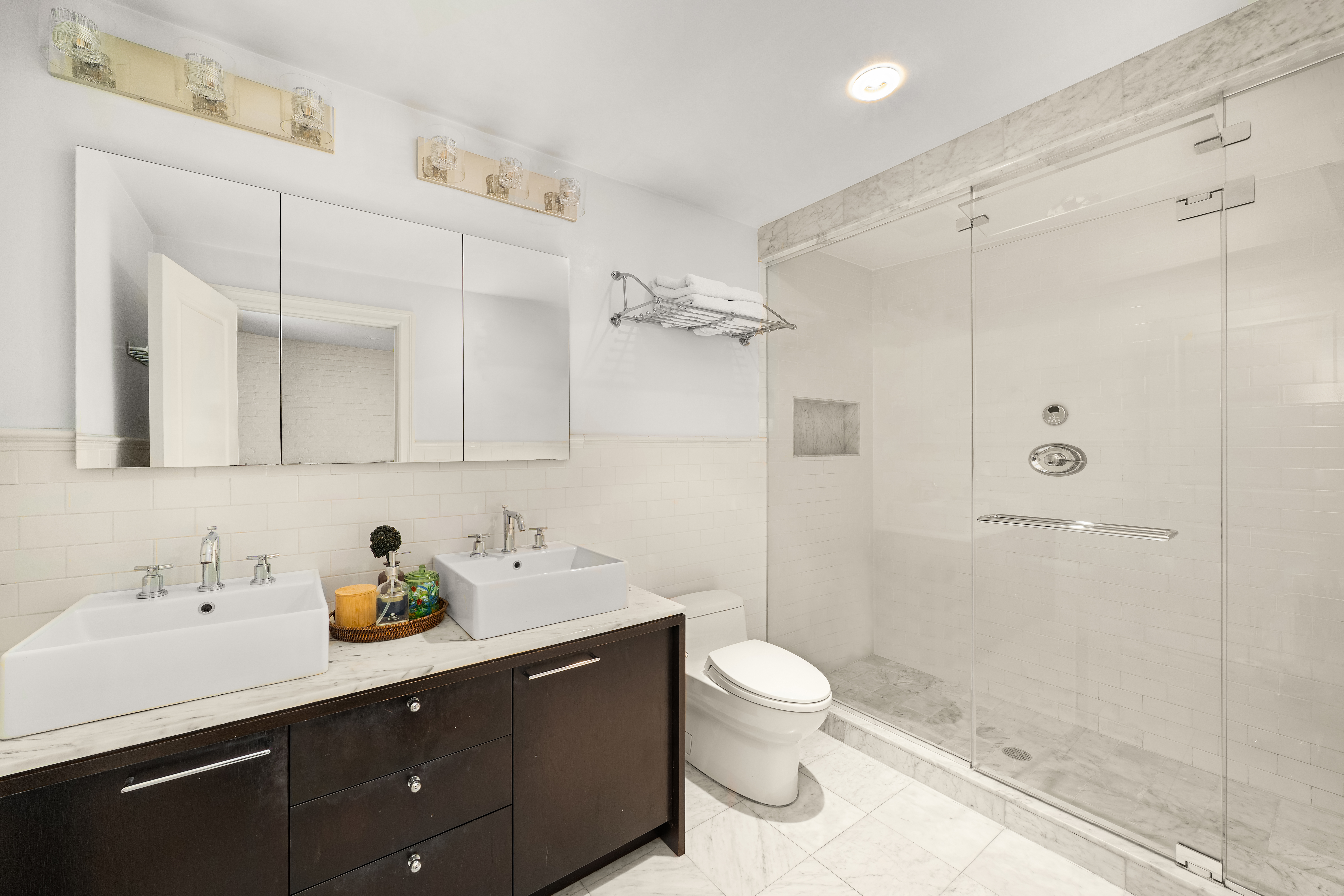 20-26 North Moore Street, Unit 4W Manhattan, NY 10013 - Photo 13 of 24 a bathroom with a sink a toilet and shower