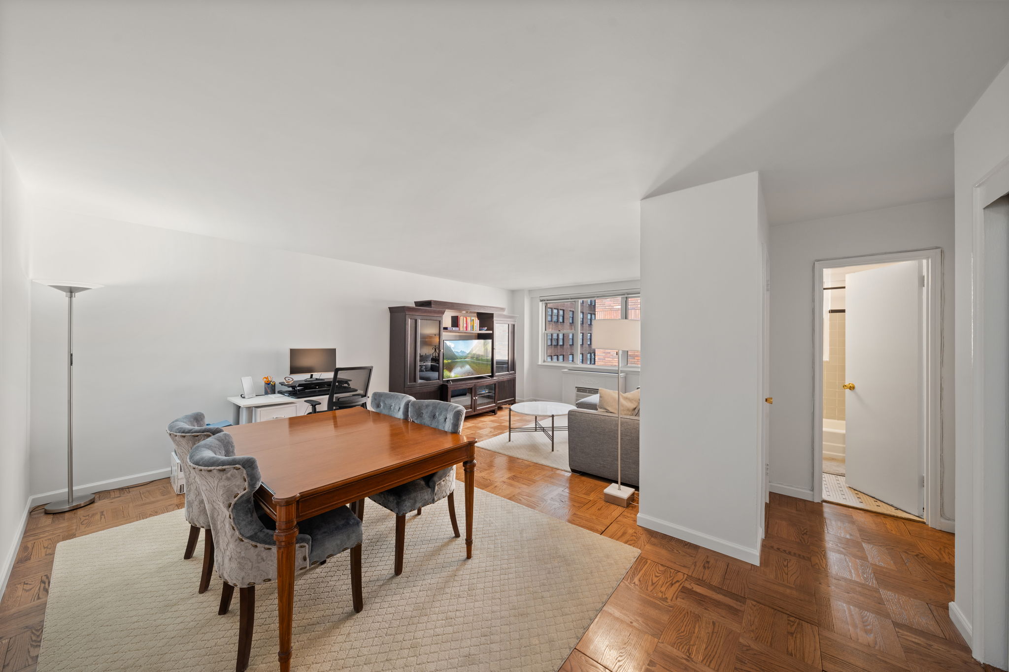 139 East 33rd Street, Unit 11L Manhattan, NY 10016 - Photo 4 of 15 a view of a dining room with furniture and wooden floor