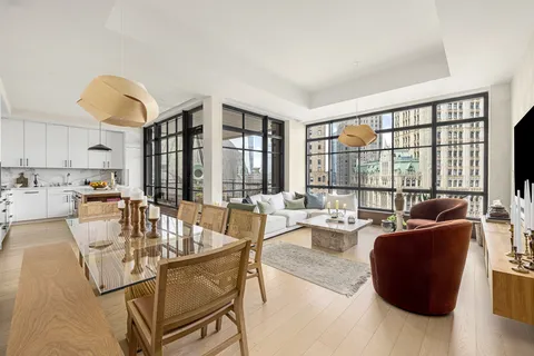 a living room with fireplace furniture and a large window