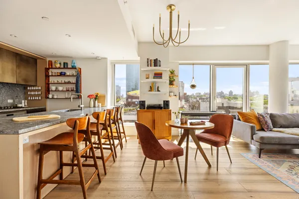 a dining room with furniture a chandelier and wooden floor