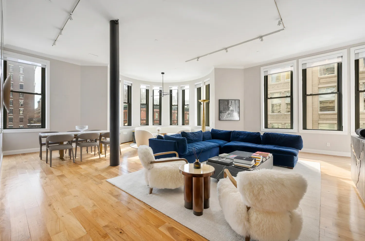 a living room with furniture and floor to ceiling windows