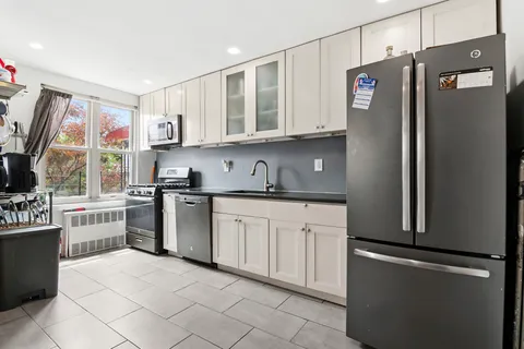 a kitchen with stainless steel appliances granite countertop a refrigerator sink and cabinets