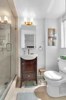 a bathroom with a sink toilet and shower