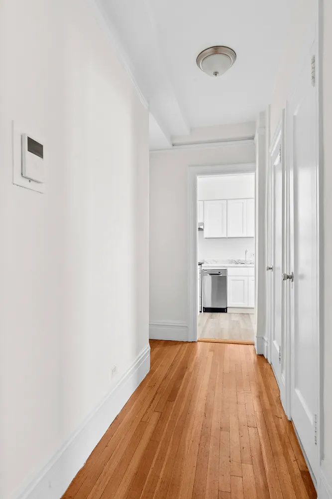 a view of a room with wooden floor closet and windows