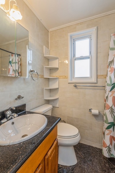 224-46 Horace Harding Expressway, Unit 630 Queens, NY 11364 - Photo 18 of 29 a bathroom with a granite countertop sink a toilet and a mirror