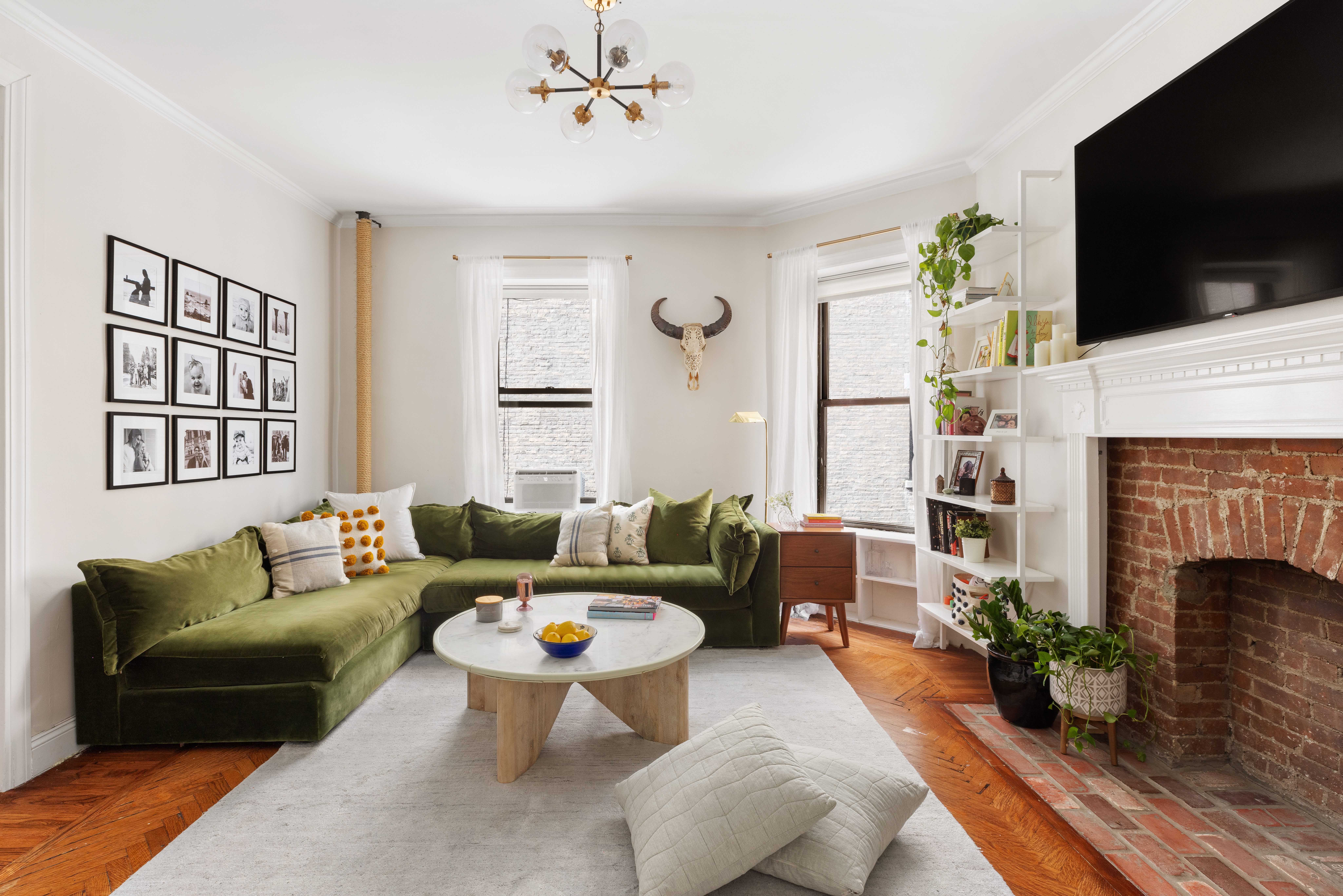 310 West 99th Street, Unit 308 Manhattan, NY 10025 - Photo 2 of 10 a living room with furniture a flat screen tv and a fireplace