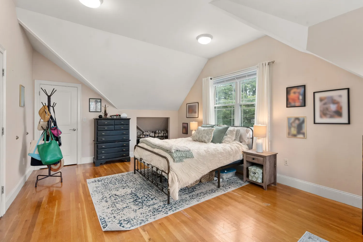 a bedroom with a bed table and a flat screen tv