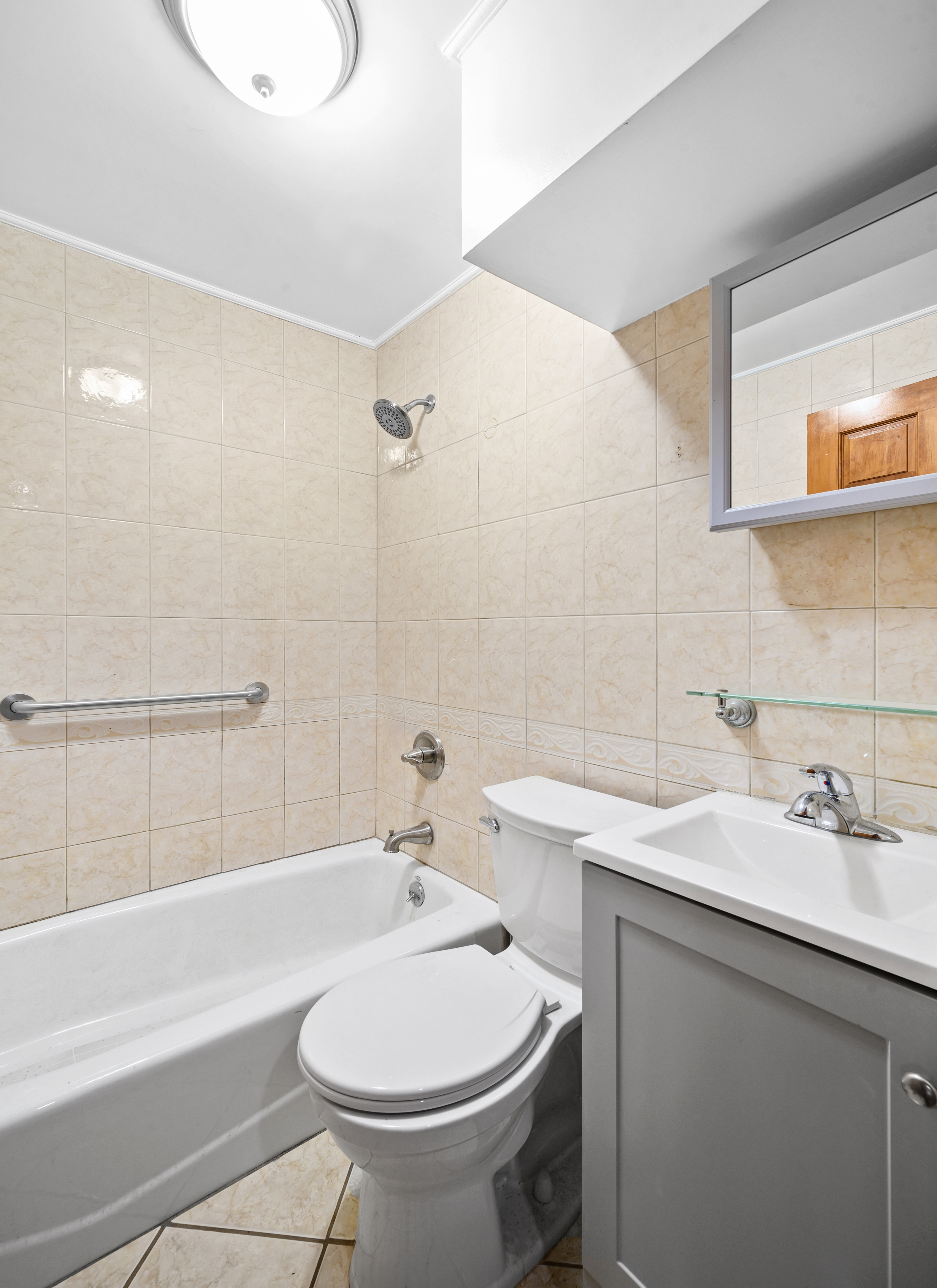 808 Lexington Avenue, Unit 1 Brooklyn, NY 11221 - Photo 7 of 8 a bathroom with a sink toilet and shower