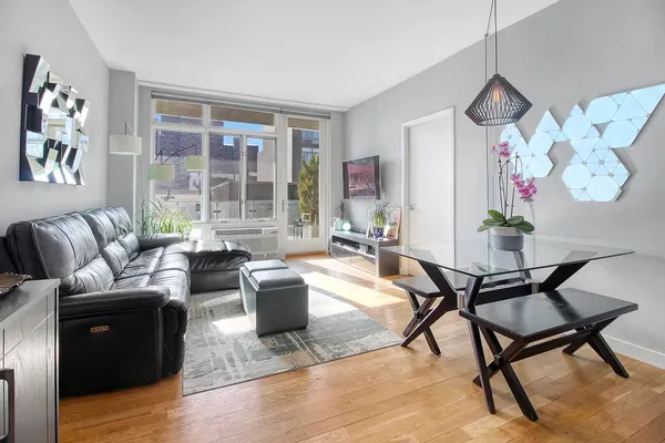 a living room with furniture or couch and a floor to ceiling window
