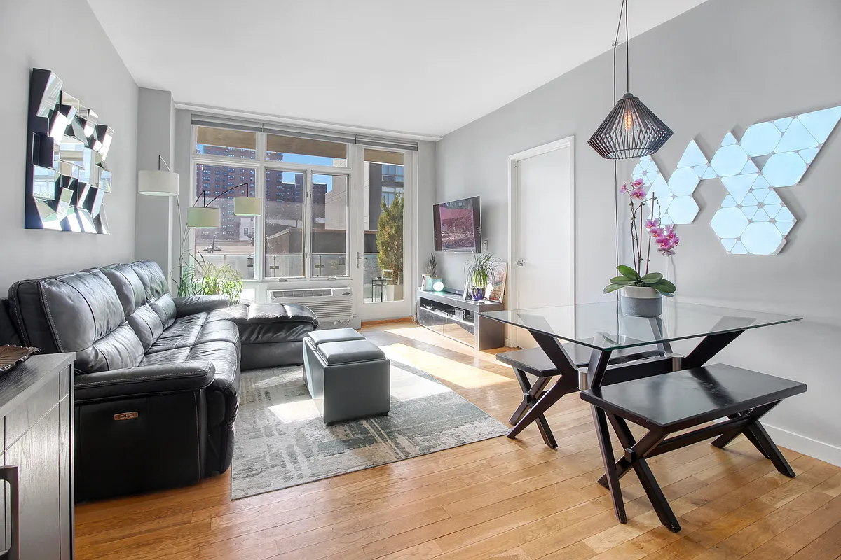 342 East 110th Street, Unit 5E Manhattan, NY 10029 - Photo 1 of 18 a living room with furniture or couch and a floor to ceiling window
