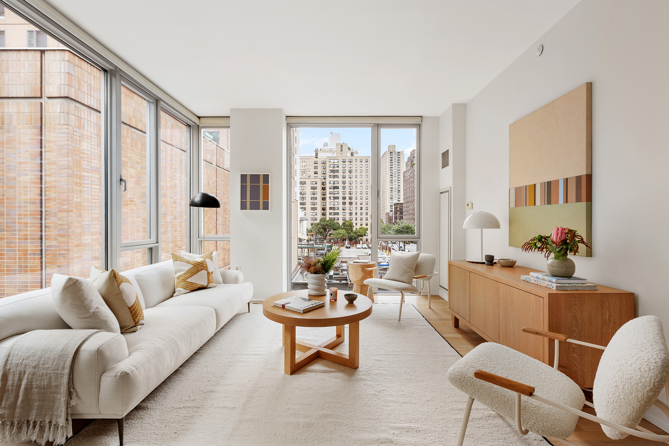 110 3rd Avenue, Unit 4B Manhattan, NY 10003 - Photo 2 of 15 a living room with furniture and a large window
