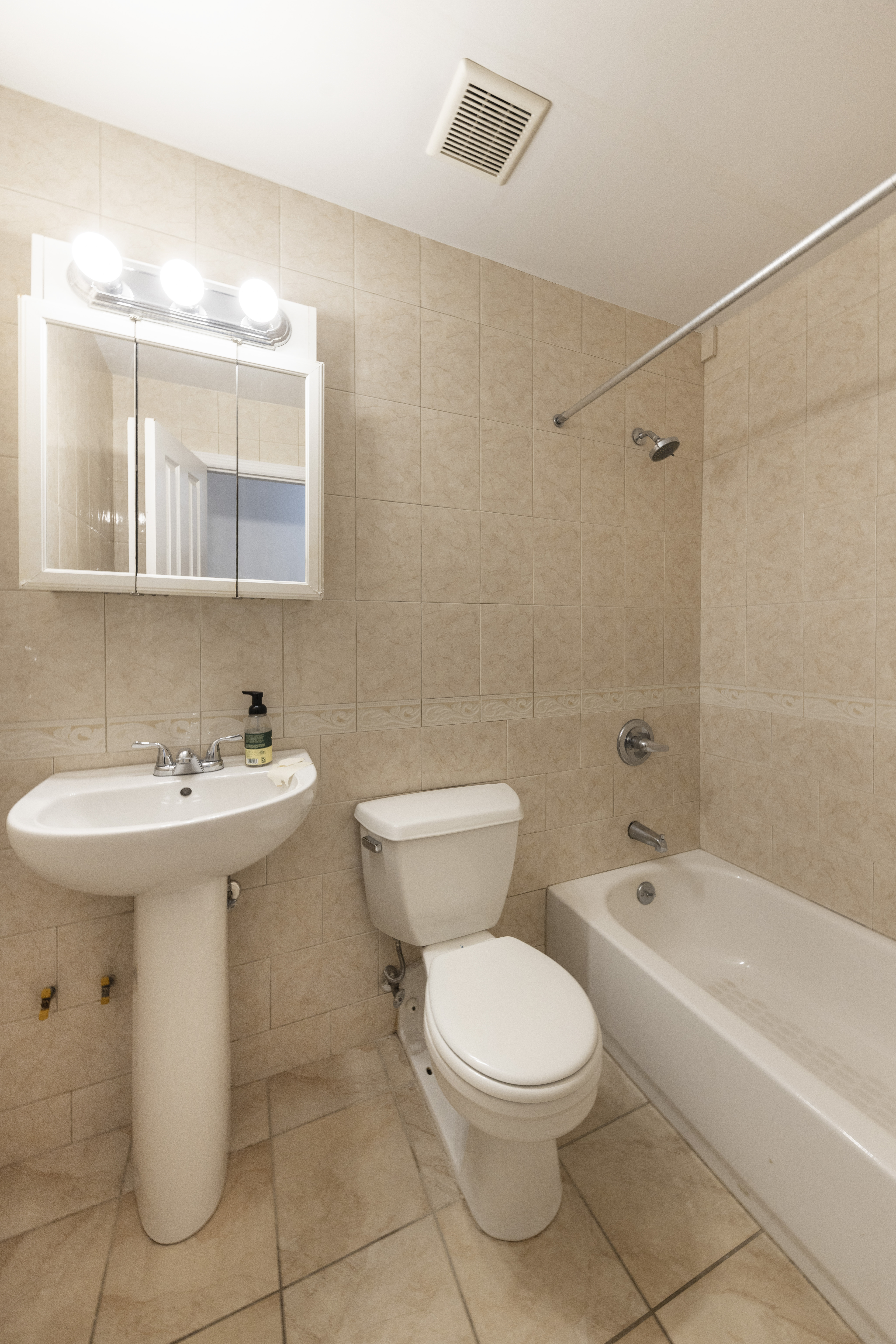 1384 Lexington Avenue, Unit 2 Manhattan, NY 10128 - Photo 6 of 11 a bathroom with a sink a toilet and shower