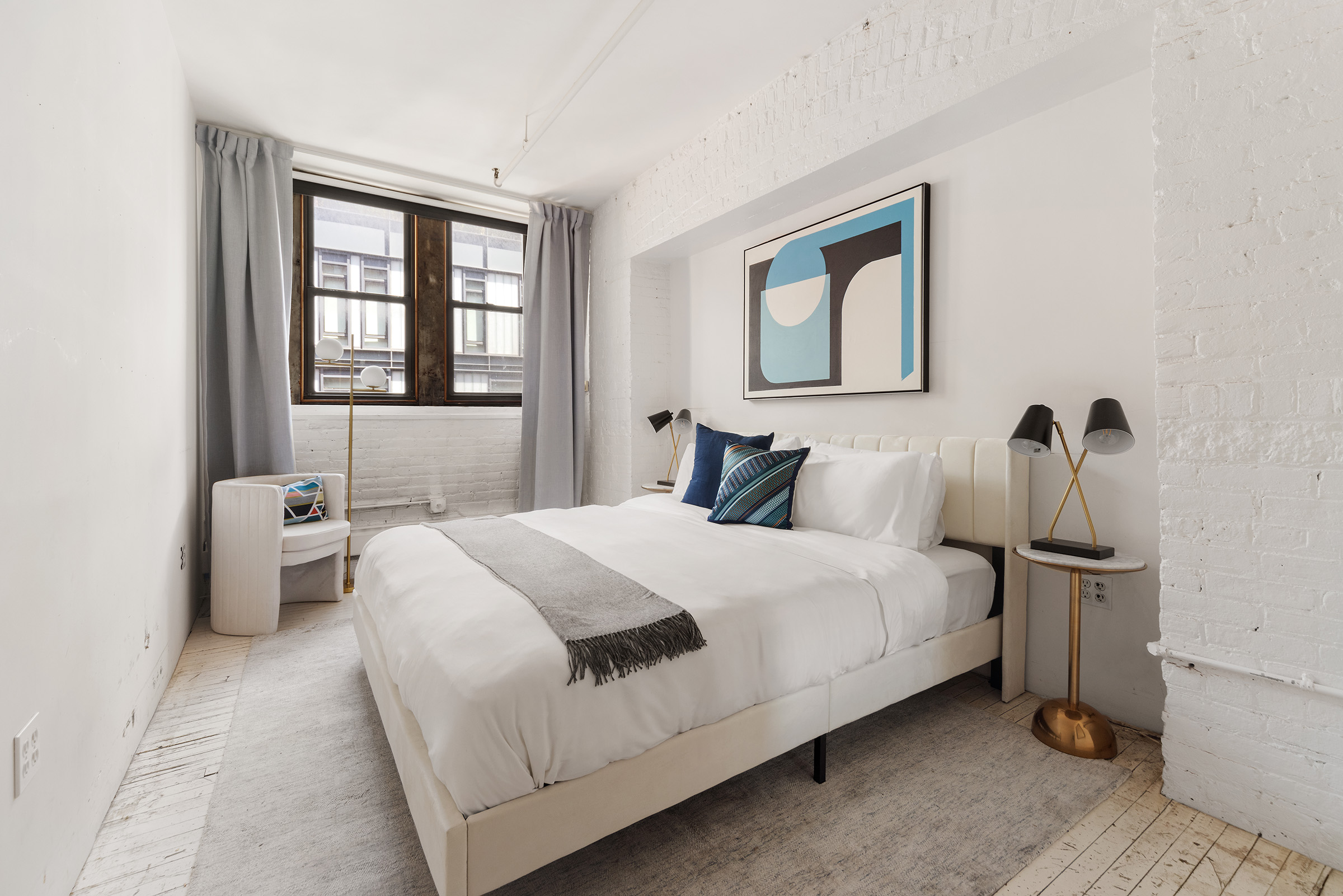 10 Leonard Street, Unit 6N Manhattan, NY 10013 - Photo 4 of 12 a bedroom with a bed and a large window