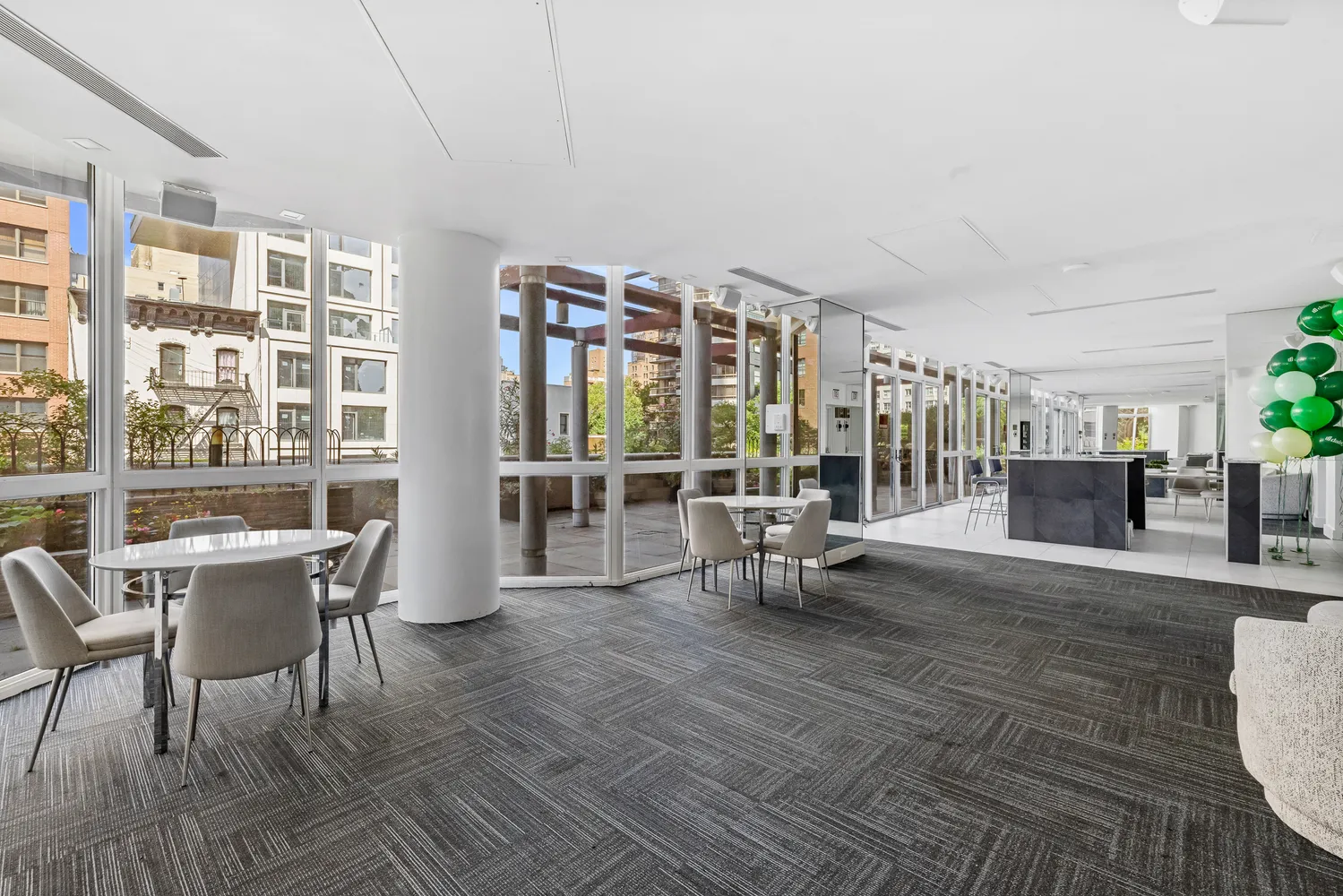 a living room with furniture and a floor to ceiling window