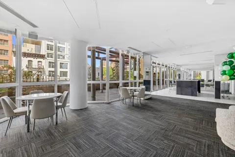 a living room with furniture and a floor to ceiling window