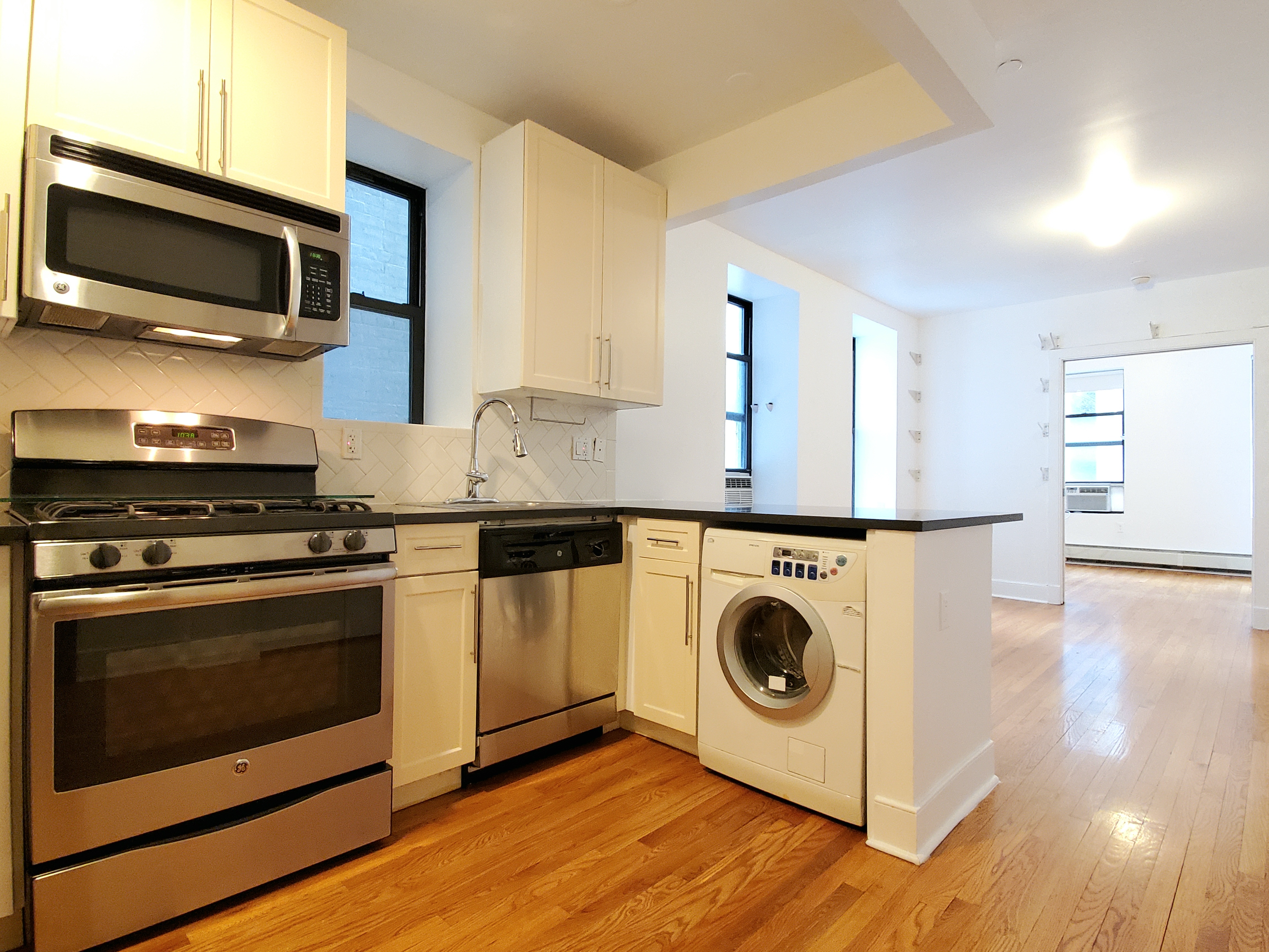 a kitchen with a stove and a microwave