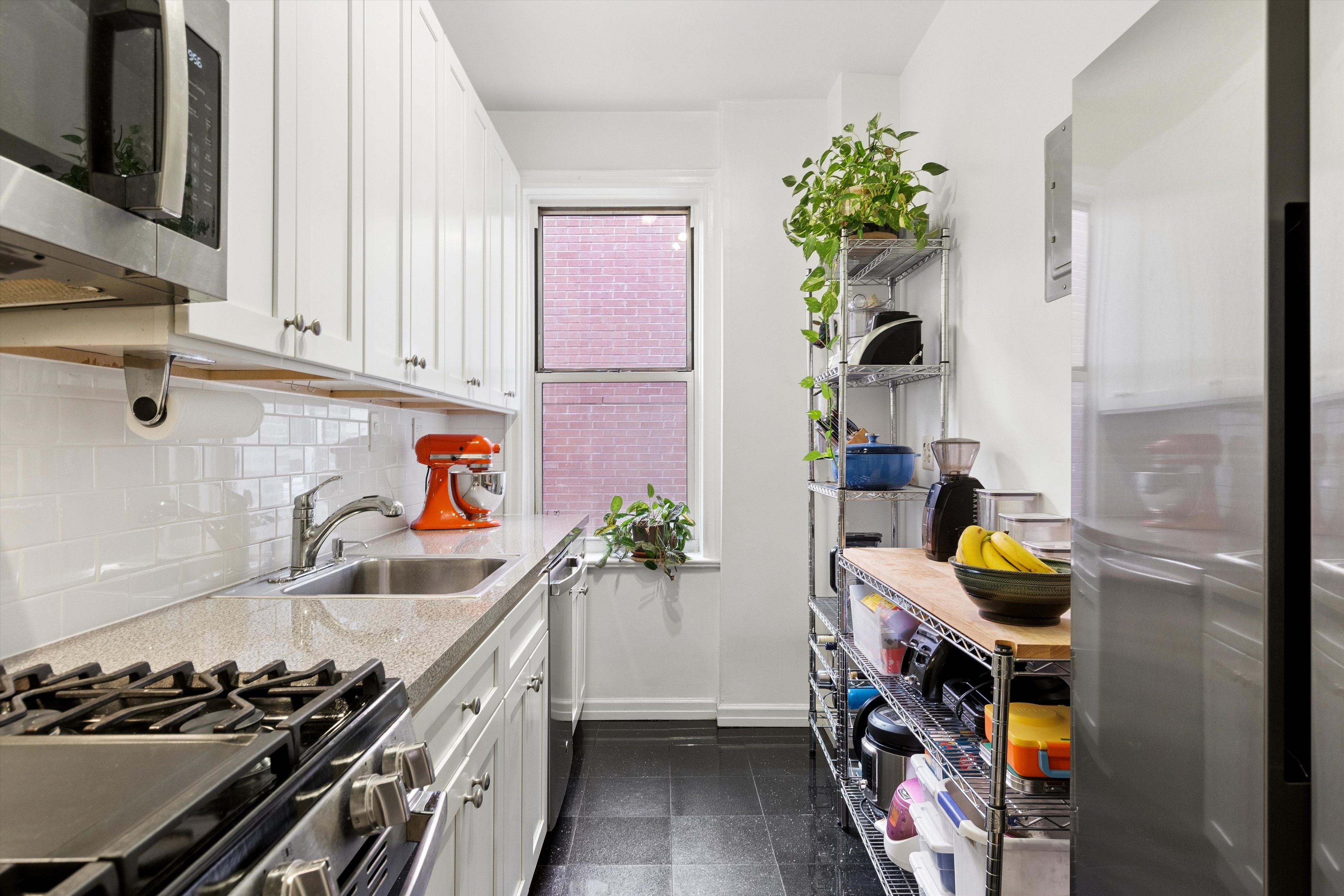 680 West 204th Street, Unit 5F Manhattan, NY 10034 - Photo 4 of 15 a kitchen with stainless steel appliances granite countertop a stove and cabinets