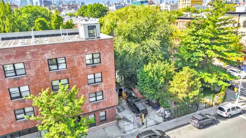 a view of a brick house with a yard
