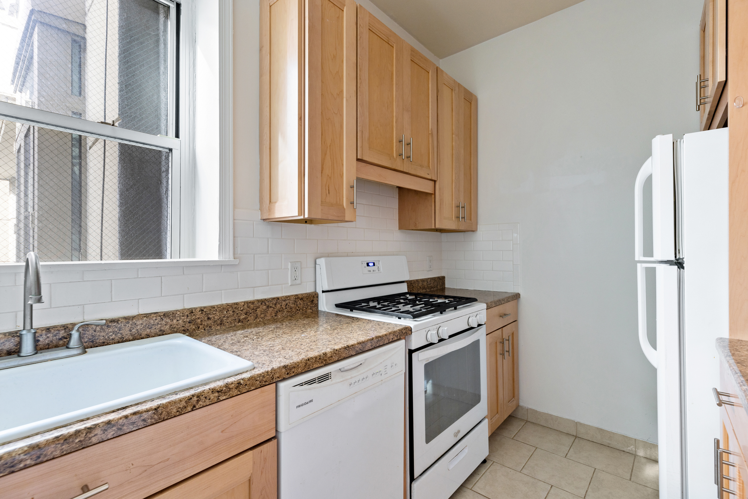 136 East 30th Street, Unit 3R Manhattan, NY 10016 - Photo 10 of 23 a kitchen with stainless steel appliances granite countertop a refrigerator and a sink