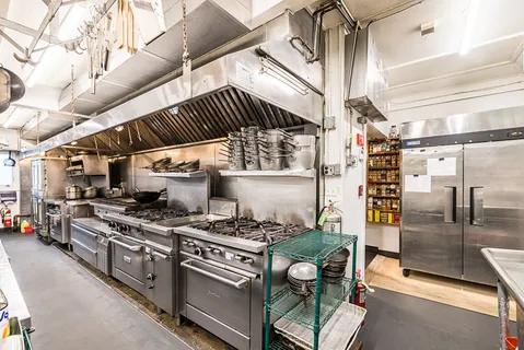 a kitchen with a stove and a refrigerator