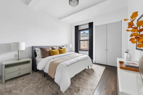 a spacious bedroom with a bed and a window