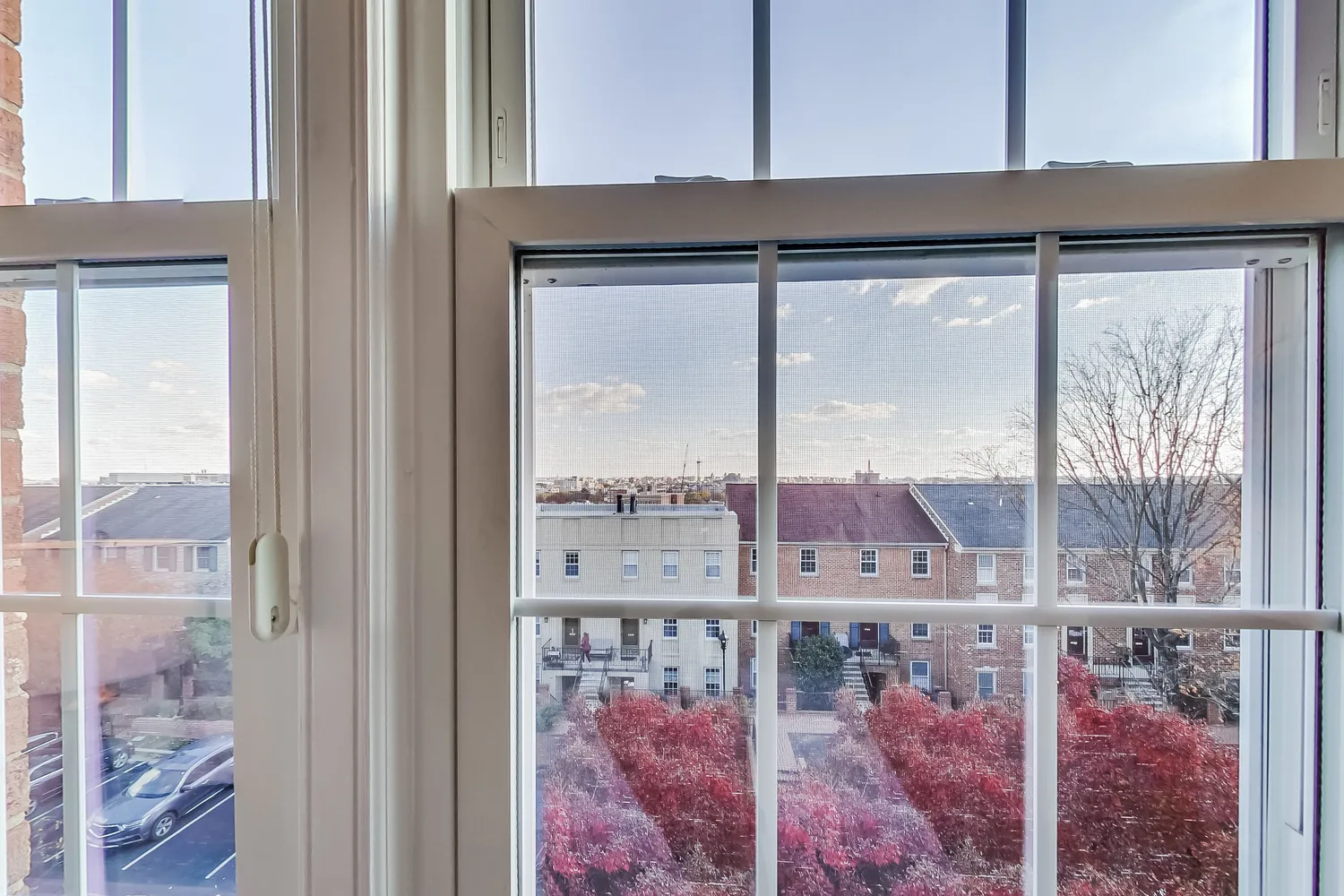 a view of a glass door with a yard from a window