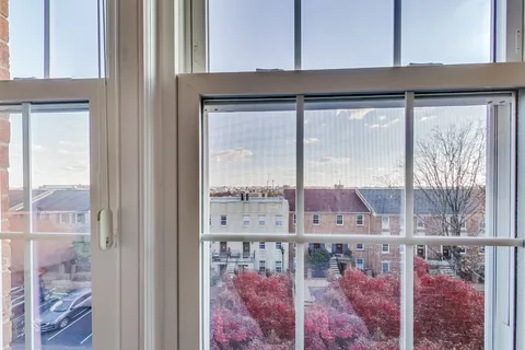 a view of a glass door with a yard from a window