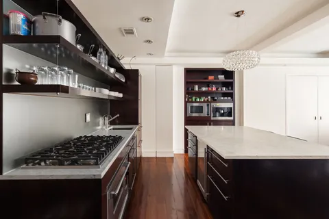 a kitchen with stainless steel appliances granite countertop a stove and a refrigerator