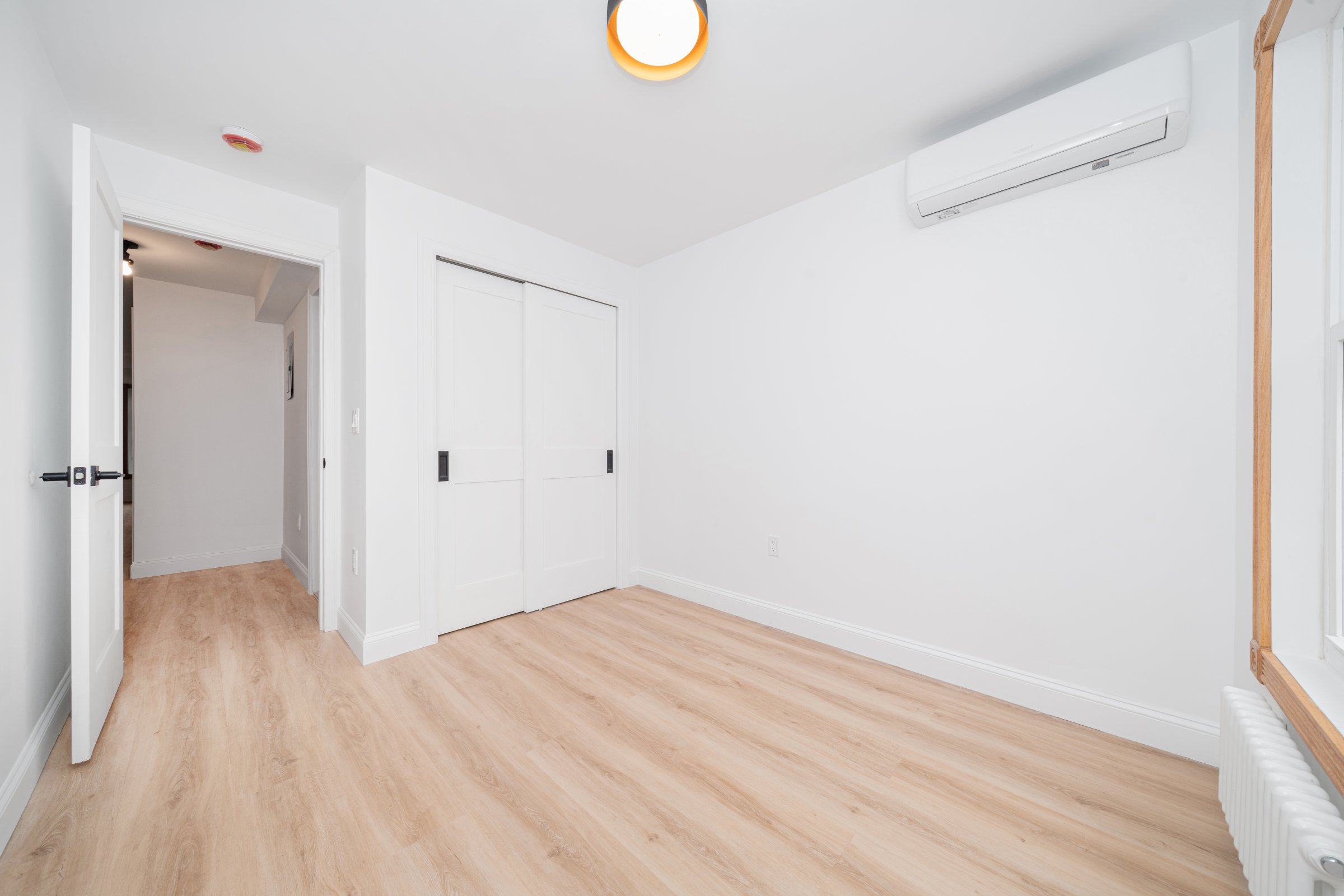 248 Eldert Street, Unit 1 Brooklyn, NY 11207 - Photo 11 of 12 a view of empty room with wooden floor