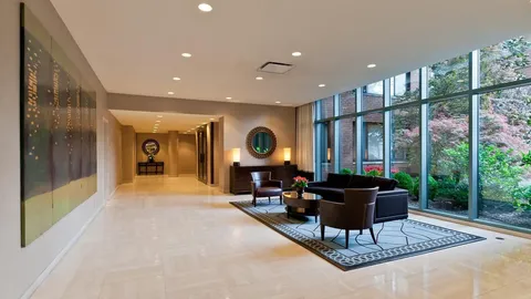 a living room with furniture a rug and a large window