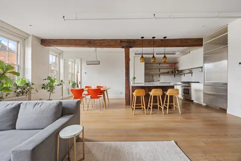 a living room with lots of furniture and kitchen view