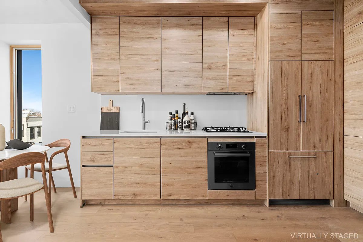 496 Wilson Avenue, Unit 4A Brooklyn, NY 11221 - Photo 2 of 10 a kitchen with stainless steel appliances granite countertop a stove a sink and a refrigerator