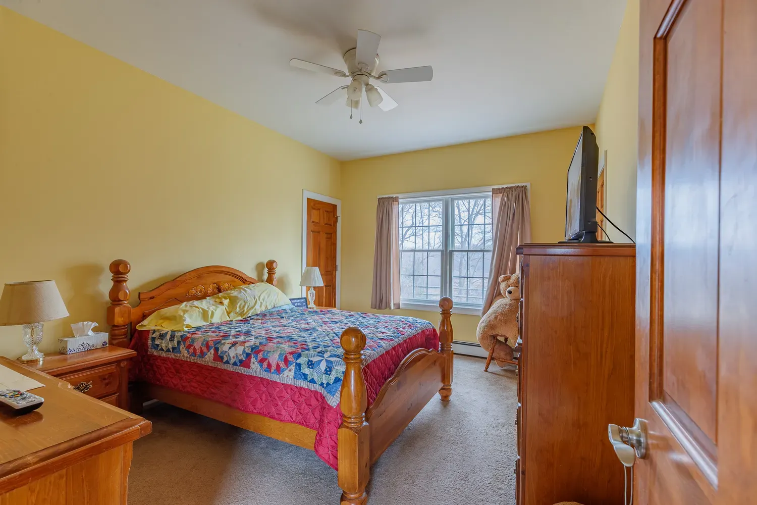 a bed room with a bed window and a flat screen tv