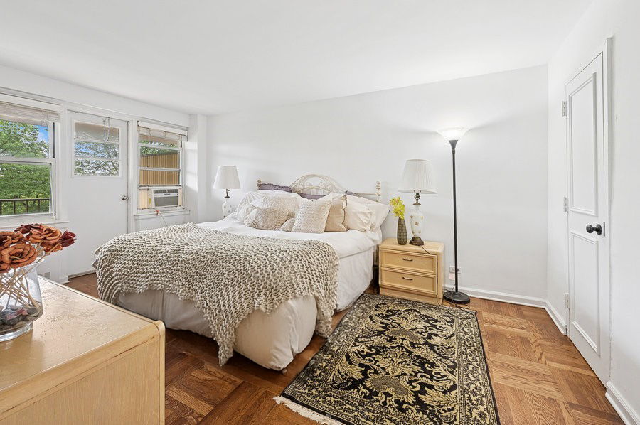 4525 Henry Hudson Parkway West, Unit 506 Bronx, NY 10471 - Photo 7 of 12 a bedroom with a bed and wooden floor