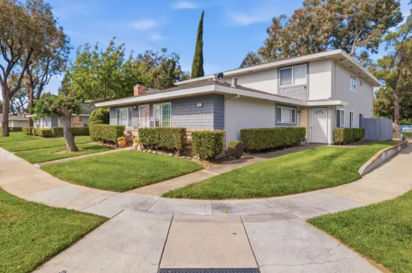 a view of a yard in front view of a house