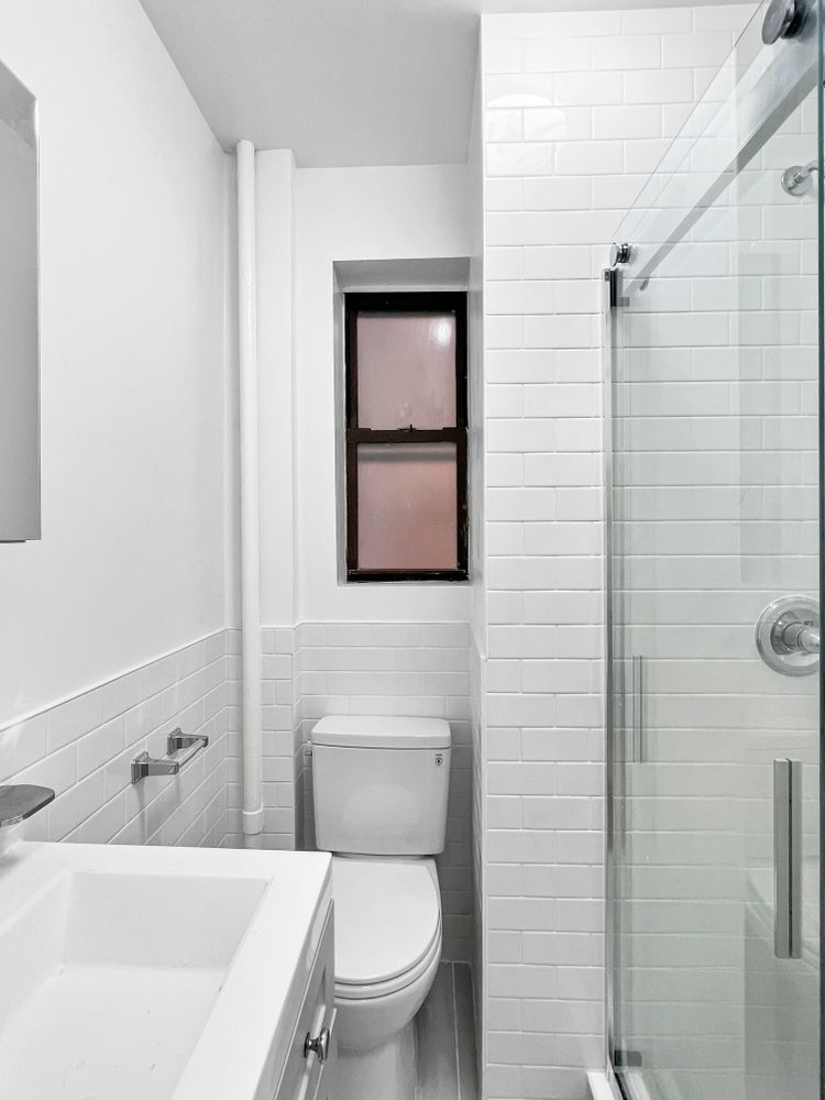 270 East 78th Street, Unit 1 Manhattan, NY 10075 - Photo 5 of 6 a bathroom with a toilet a sink and mirror