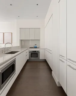 a kitchen with white cabinets and white appliances